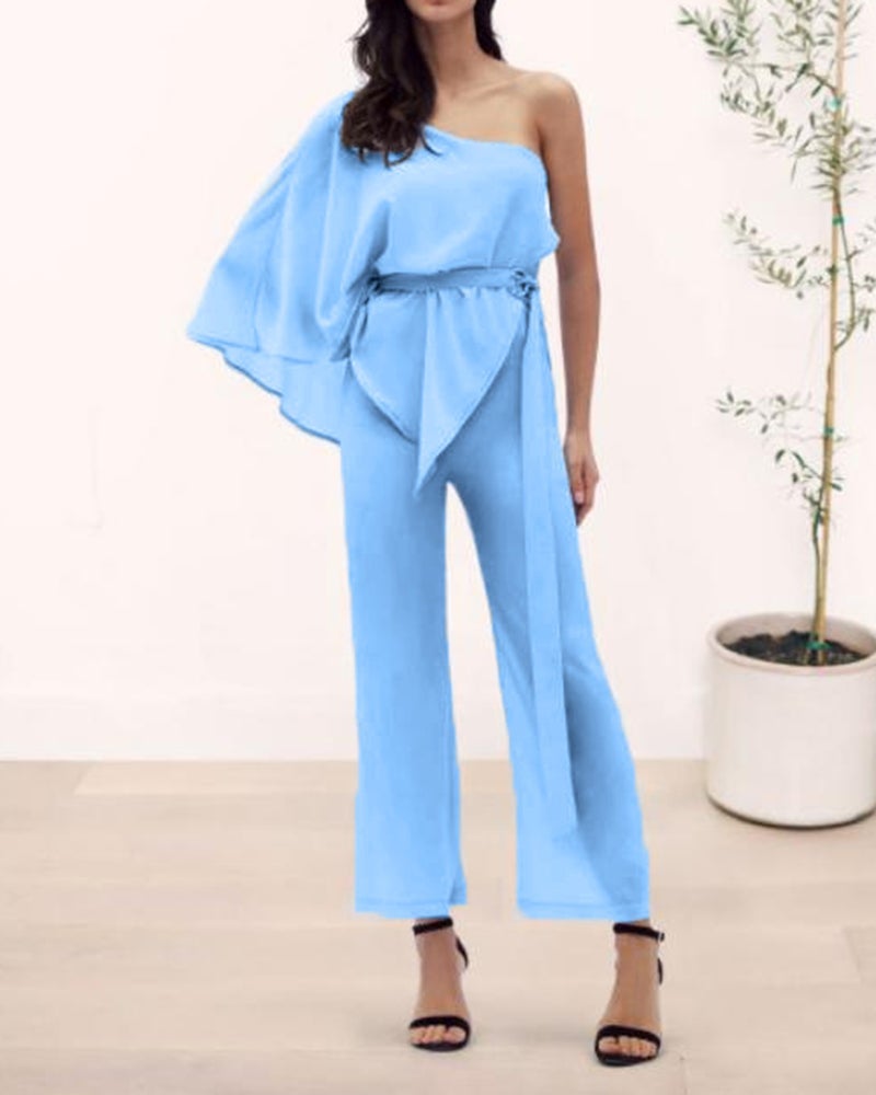 The straight leg of the high-waisted jumpsuit includes the belt